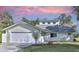 Charming two-story home with a white garage door and landscaping at 10221 Elgin Blvd, Spring Hill, FL 34608