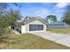 Tan home with a screened garage and walkway, and a partial view of the neighbor's home at 10221 Elgin Blvd, Spring Hill, FL 34608