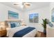 Spacious bedroom with ceiling fan, large window, and coastal decor at 10221 Elgin Blvd, Spring Hill, FL 34608