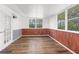 Bright sunroom with wood flooring and multiple windows at 10221 Elgin Blvd, Spring Hill, FL 34608