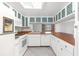 Bright kitchen with white cabinets, wood countertops, and modern appliances at 10221 Elgin Blvd, Spring Hill, FL 34608