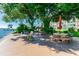 Relaxing shaded waterfront patio with picnic tables and umbrellas at 1847 Shore S Dr # 614, South Pasadena, FL 33707