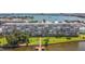 Aerial view of waterfront building with lush landscaping, dock, and bay access at 1847 Shore S Dr # 614, South Pasadena, FL 33707