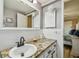 Bathroom features granite countertop, black matte faucet, and wave patterned wall tile at 1847 Shore S Dr # 614, South Pasadena, FL 33707
