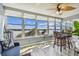 Bright sunroom with water views and seating area at 1847 Shore S Dr # 614, South Pasadena, FL 33707