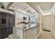 Updated kitchen with island, white cabinets, and stainless steel appliances at 1847 Shore S Dr # 614, South Pasadena, FL 33707