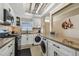 Modern kitchen with white cabinets, granite countertops and island at 1847 Shore S Dr # 614, South Pasadena, FL 33707