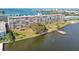Aerial view of waterfront condo building with a dock and lush landscaping at 1847 Shore S Dr # 614, South Pasadena, FL 33707