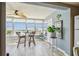 Sunroom with water views and a small table and chairs at 1847 Shore S Dr # 614, South Pasadena, FL 33707