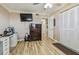 Home office with wood laminate flooring, built-in storage, and a large TV at 1847 Shore S Dr # 614, South Pasadena, FL 33707