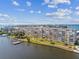 Aerial view of waterfront condo building with pool, dock, and lush landscaping at 1847 Shore S Dr # 614, South Pasadena, FL 33707