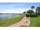 Scenic waterfront walkway with a relaxing bench at 1847 Shore S Dr # 614, South Pasadena, FL 33707