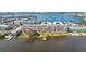 Aerial view of waterfront condo building with pool, dock, and surrounding buildings at 1847 Shore S Dr # 614, South Pasadena, FL 33707