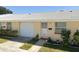 Quaint condo with a white garage door and well-manicured landscaping at 4931 Docner St # 4931, New Port Richey, FL 34652