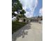 Inviting single-Gathering home with a well-kept lawn, attached garage, and a charming stucco facade, all under a sunny sky at 8088 Spanish Oak Dr, Spring Hill, FL 34606