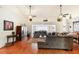 Spacious living room featuring hardwood floors, sectional sofa and ceiling fan at 8088 Spanish Oak Dr, Spring Hill, FL 34606