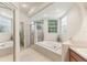 Spa-like Primary bathroom with walk-in shower and tub at 8088 Spanish Oak Dr, Spring Hill, FL 34606
