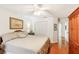 King-size bed in a well-lit bedroom with hardwood floors at 8088 Spanish Oak Dr, Spring Hill, FL 34606