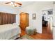 Bedroom with wood floors, ceiling fan, and armoire at 8088 Spanish Oak Dr, Spring Hill, FL 34606