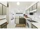 Galley kitchen with stainless steel appliances and tile floors at 8088 Spanish Oak Dr, Spring Hill, FL 34606