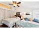 Bedroom with two twin beds and ceiling fan at 8088 Spanish Oak Dr, Spring Hill, FL 34606