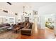 Open living room with hardwood floors, sectional sofa and high ceilings at 8088 Spanish Oak Dr, Spring Hill, FL 34606