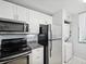 Modern kitchen with white cabinets, granite countertops, and stainless steel appliances at 2424 W Tampa Bay Blvd # L-302, Tampa, FL 33607