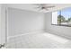 Bright bedroom with tile floors and large window at 2424 W Tampa Bay Blvd # L-302, Tampa, FL 33607