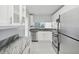 Modern kitchen with white cabinets, granite countertops, and stainless steel appliances at 2424 W Tampa Bay Blvd # L-302, Tampa, FL 33607