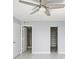 Bright bedroom with ceiling fan, spacious closet, and access to bathroom at 2424 W Tampa Bay Blvd # L-302, Tampa, FL 33607