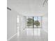 Bright living room with tile floors and sliding glass doors leading to a balcony at 2424 W Tampa Bay Blvd # L-302, Tampa, FL 33607