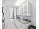 Modern kitchen with white cabinets, granite countertops, and stainless steel appliances at 2424 W Tampa Bay Blvd # L-302, Tampa, FL 33607