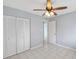 Bedroom with tile floors, ceiling fan, and built-in closet at 2424 W Tampa Bay Blvd # L-302, Tampa, FL 33607