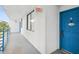 Building hallway with blue door to unit L-302 at 2424 W Tampa Bay Blvd # L-302, Tampa, FL 33607