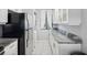 Modern kitchen with white cabinets, granite countertops, and stainless steel appliances at 2424 W Tampa Bay Blvd # L-302, Tampa, FL 33607