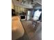 Bright kitchen with light cabinets, tile floor, and an eat-in breakfast area at 12409 Dearborn Dr # E, Hudson, FL 34667