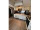 Spacious kitchen featuring white cabinets and a matching dishwasher at 12409 Dearborn Dr # E, Hudson, FL 34667
