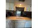 Kitchen view of sink and cabinets with a view to the living area at 12409 Dearborn Dr # E, Hudson, FL 34667