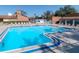 Large community pool with lounge chairs and ample space for relaxation at 12409 Dearborn Dr # E, Hudson, FL 34667