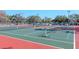 Well-maintained tennis courts surrounded by lush greenery, perfect for active residents at 12409 Dearborn Dr # E, Hudson, FL 34667