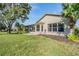 Tan house exterior with screened patio at 1533 Westerham Loop, Trinity, FL 34655