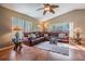 Spacious living room featuring a large leather sectional sofa and wood flooring at 1533 Westerham Loop, Trinity, FL 34655