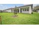 The backyard features a well-maintained lawn and a covered patio area, great for outdoor relaxation at 19395 Sheltered Hill Dr, Brooksville, FL 34601