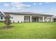 The backyard features a well-maintained lawn and a covered patio area, great for outdoor relaxation at 19395 Sheltered Hill Dr, Brooksville, FL 34601