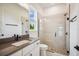 Modern bathroom featuring a glass shower with stone floor, a vanity, and a large window at 19395 Sheltered Hill Dr, Brooksville, FL 34601