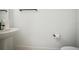 Powder room featuring a pedestal sink, large mirror, toilet, and neutral paint at 19395 Sheltered Hill Dr, Brooksville, FL 34601