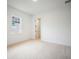 Empty bedroom with neutral carpet, white walls, and natural light from window at 19395 Sheltered Hill Dr, Brooksville, FL 34601