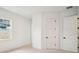 Bedroom featuring plush carpet, neutral walls, a window for natural light, and white trim at 19395 Sheltered Hill Dr, Brooksville, FL 34601