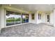 Covered patio with brick pavers features a sliding glass door entry into the home at 19395 Sheltered Hill Dr, Brooksville, FL 34601