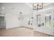 Bright entryway featuring stylish double doors, modern lighting, and hardwood floors at 19395 Sheltered Hill Dr, Brooksville, FL 34601
